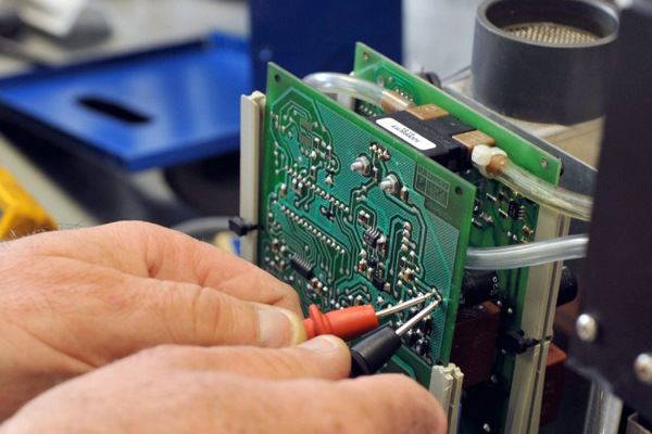 hands of an industrial maintenance technician at REEL AEMCO